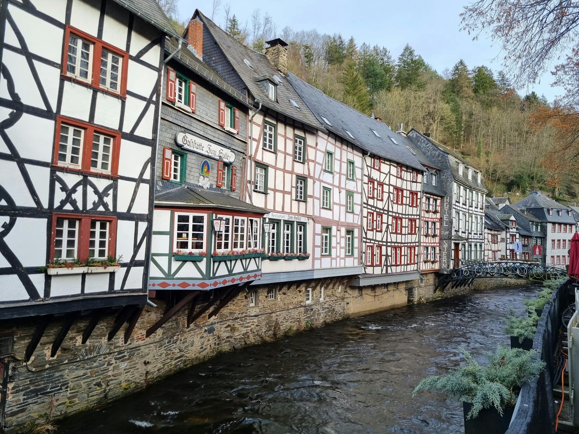 <p>The River Rur is a major river that flows through Belgium, Germany and the Netherlands. It is a tributary of the Meuse river and has a length of 164.5 km (102.2 mi). Monschau is a small resort town in the Eifel region of western Germany, located in the narrow valley of the Rur river. </p><p><br></p><p>The town has a historic center with many preserved half-timbered houses and narrow streets that date back to the Middle Ages. The town is also known for its open-air classical music festival at Burg Monschau, a castle that was once a seat of the dukes of Jülich. </p><p><br></p><p>Monschau attracts many tourists with its picturesque views, especially in the warm months 3. The Rur river is also a source of trout and salmon for local fishermen. In 2023, the river experienced a severe flooding that threatened the town of Monschau and its surroundings.</p>