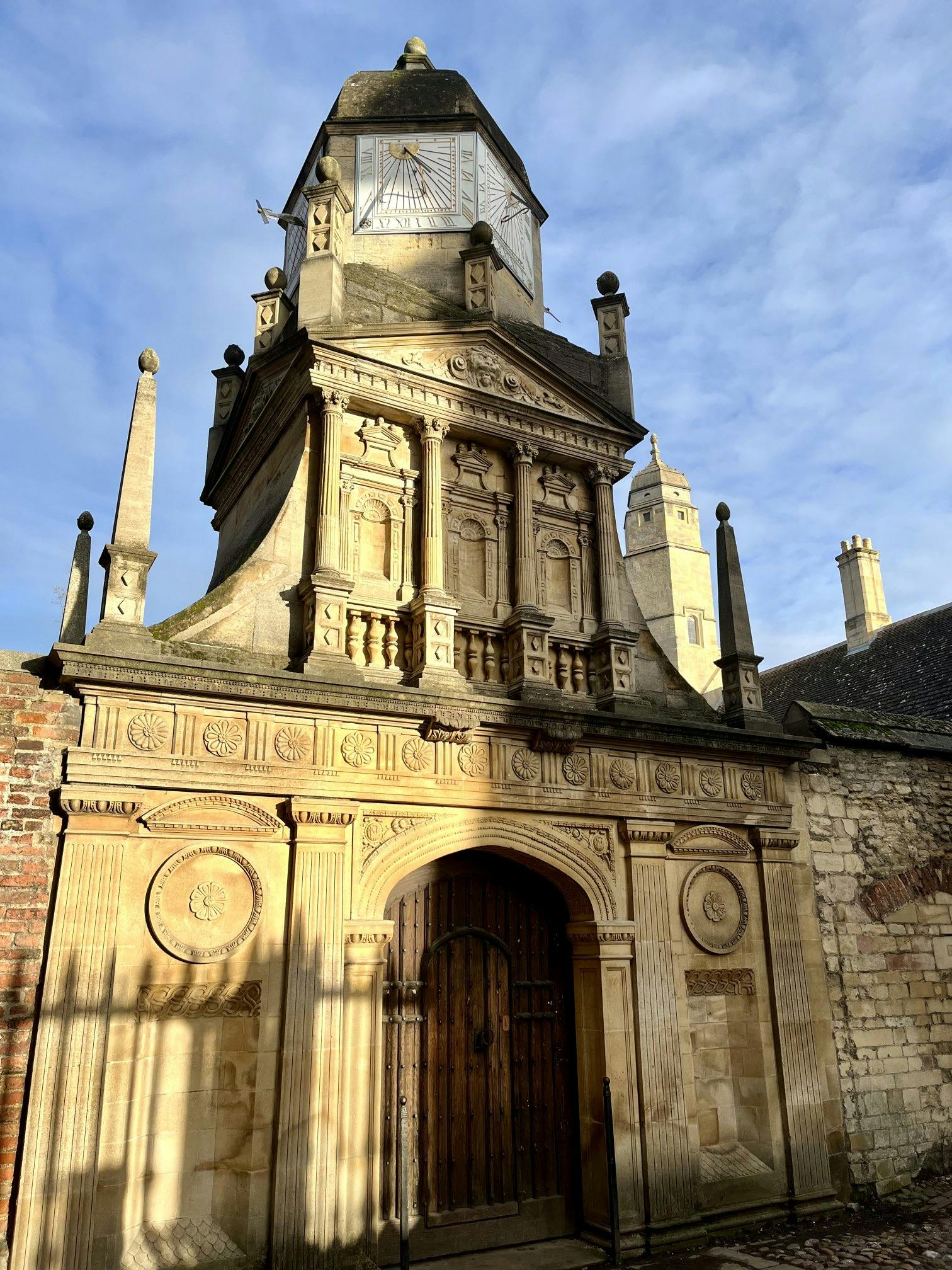 <p>The Gate of Honour is a historical landmark in Cambridge, England. It is one of the three gates that were designed by John Caius, the founder of Gonville and Caius College, in the 16th century. The other two gates are the Gate of Humility and the Gate of Virtue.</p><p><br></p><p>The Gate of Honour is a small triumphal arch that symbolizes the academic achievement of the students who pass through it. It is only used for special occasions, such as graduation ceremonies, when the students walk from the college to the Senate House to receive their degrees.</p><p><br></p><p>The Gate of Honour is decorated with various sculptures and inscriptions, such as the coat of arms of the college, the motto of John Caius, and the figures of the four evangelists. The gate is also adorned with the initials of John Caius and the date of its completion, 1573.</p><p><br></p><p>The Gate of Honour is considered a masterpiece of Renaissance architecture, and it was probably influenced by the Flemish architect Theodore de Have, who worked with John Caius on other projects. The gate is regarded as one of the most beautiful and iconic structures in Cambridge, and it has been featured in many books, paintings, and photographs.</p><p><br></p><p>The Gate of Honour has also been a target of vandalism and protest, such as when it was spray-painted by Extinction Rebellion activists in 2020, who demanded that the college divest from fossil fuels. The college condemned the act and said that it would cost thousands of pounds to restore the gate.</p>