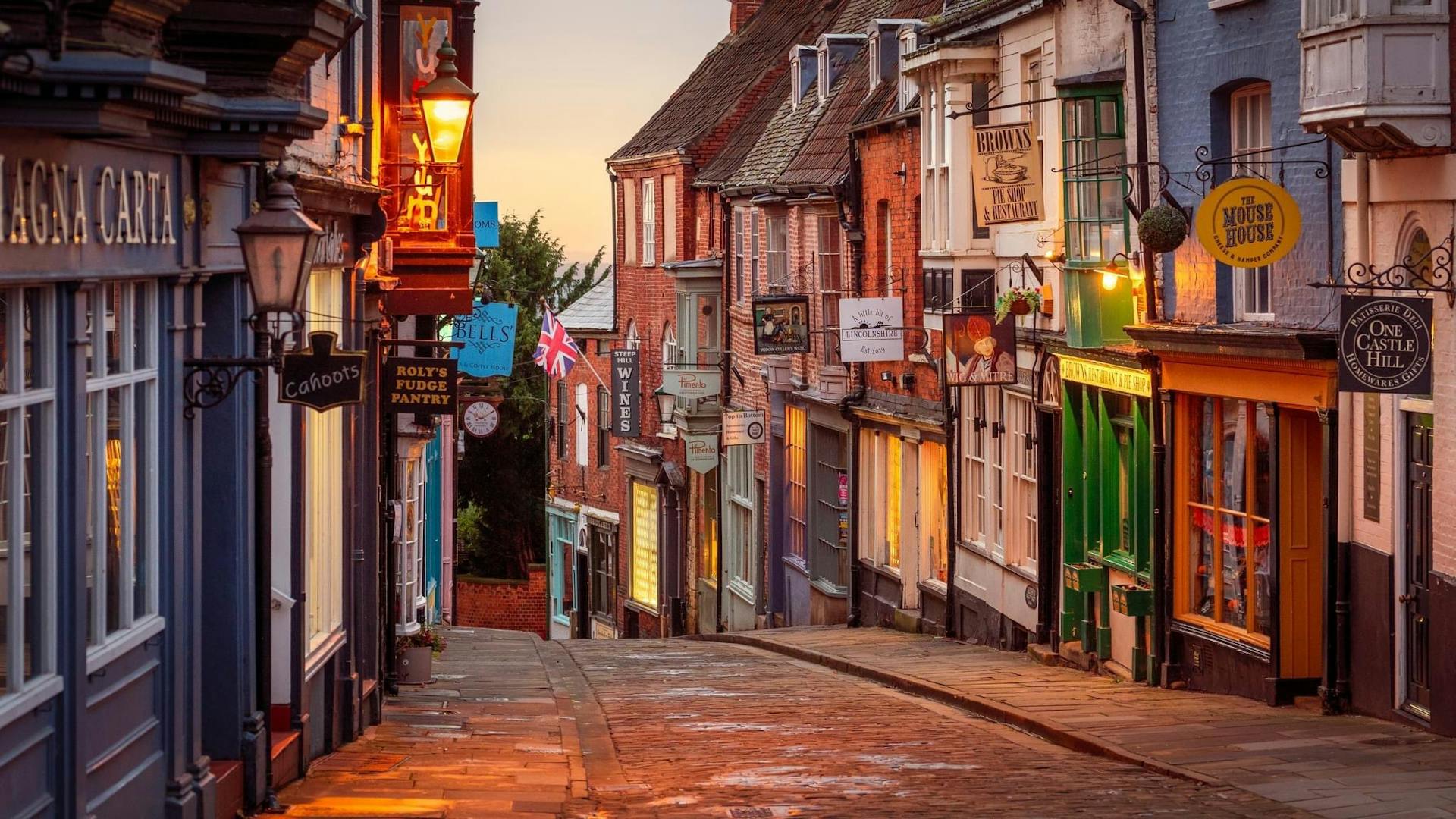 <p>Steep Hill is a famous street in the historic city of Lincoln, England. It connects the lower part of the city with the Cathedral Quarter, where Lincoln Cathedral and Lincoln Castle are located. </p><p><br></p><p>The street is very steep, with a gradient of 16.12 degrees, and is lined with independent shops, tea rooms and restaurants. It also has some Norman houses and Roman remains. </p><p><br></p><p>Steep Hill was voted Britain’s Great Street in 2012 by the Academy of Urbanism. </p>
